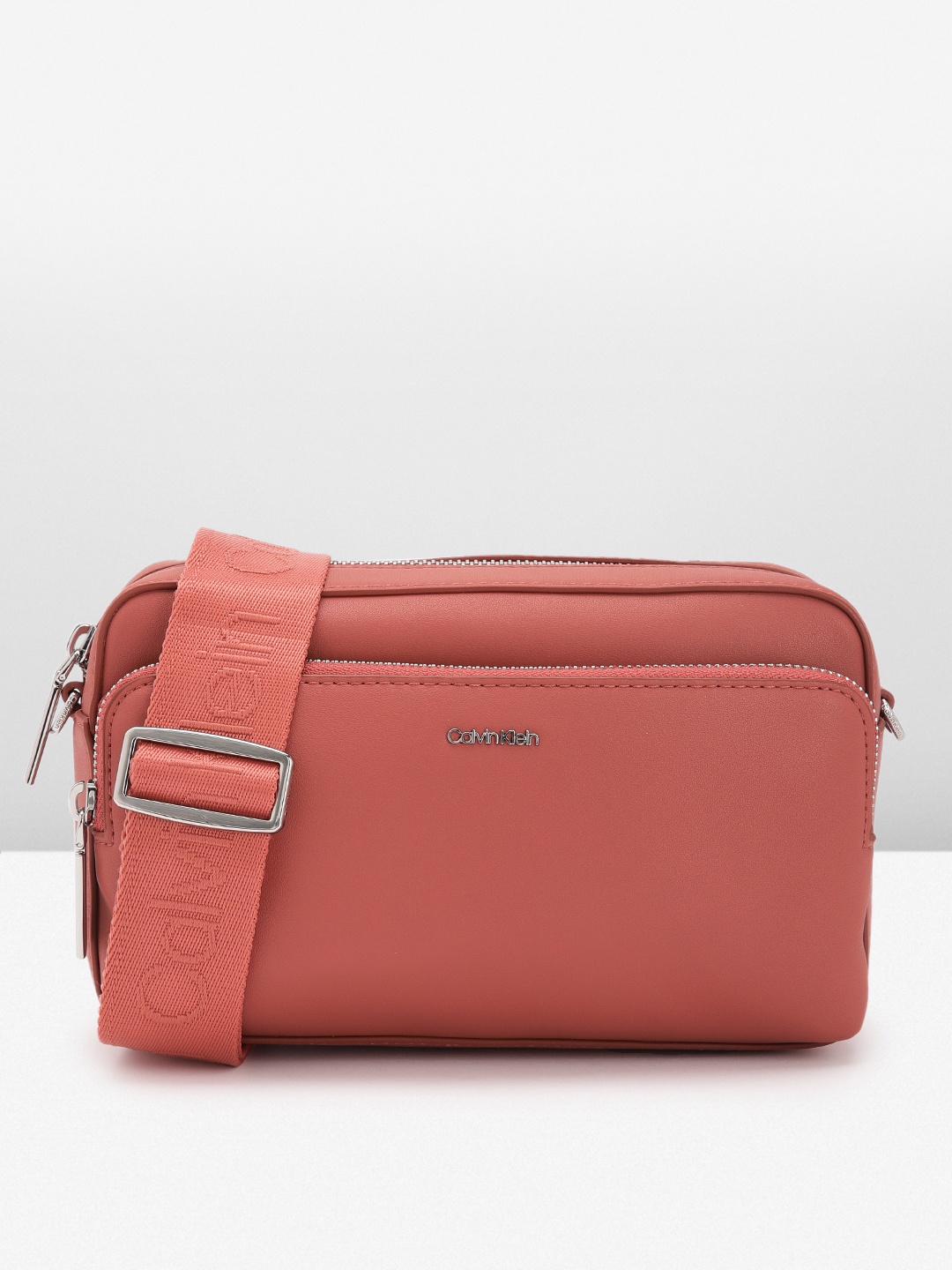 

Calvin Klein Women Solid Sling Bag, Rust