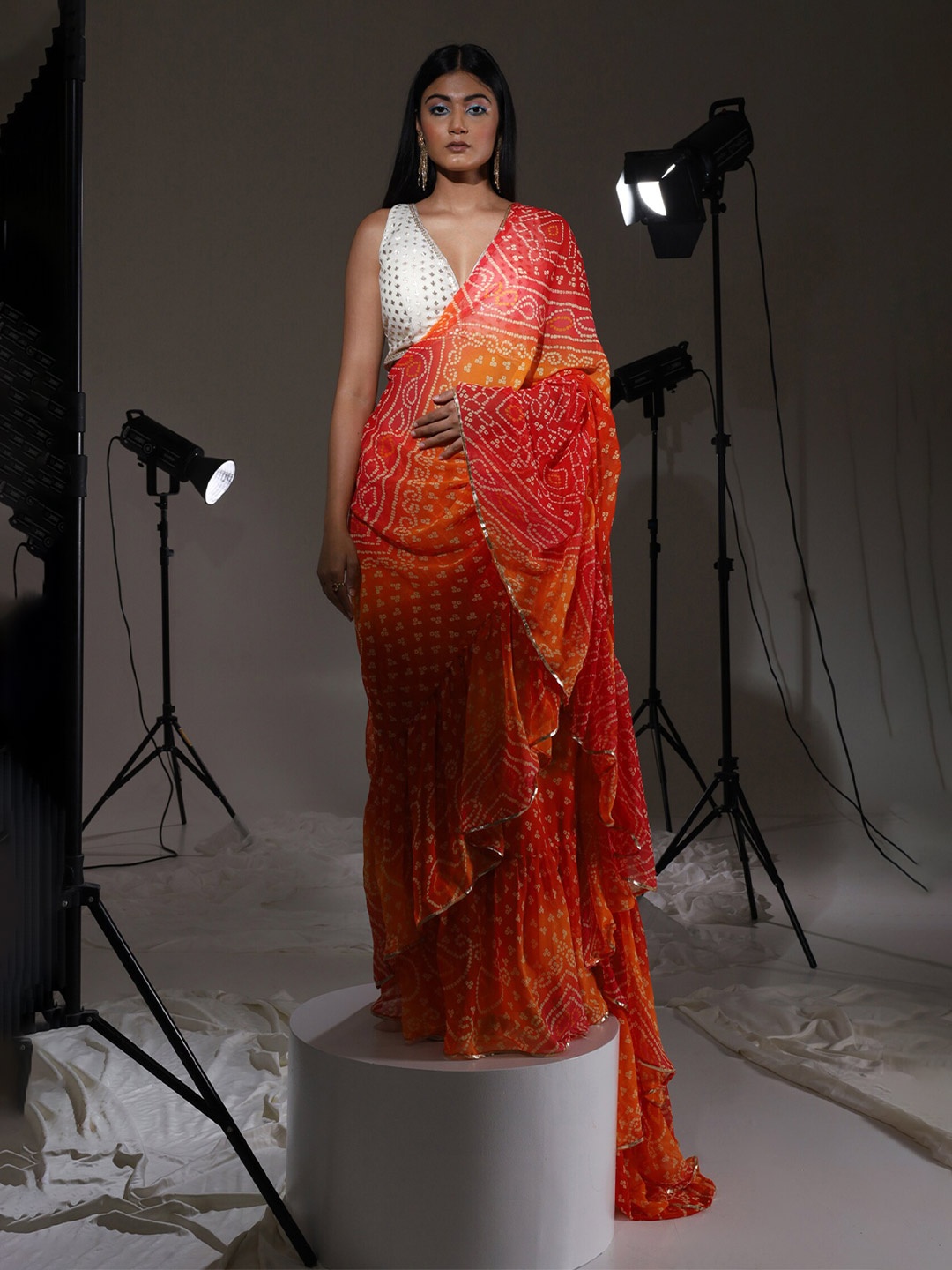 

Tikhi Imli Red Bandhani Printed Embellished Ruffles Saree