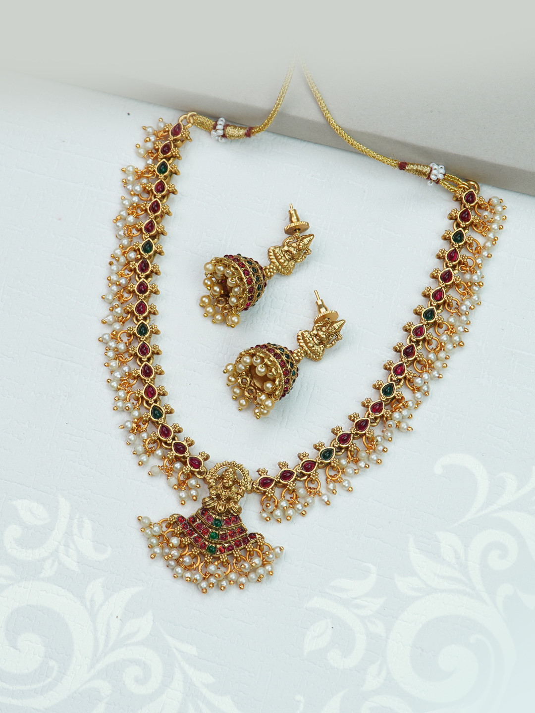 

Diksha collection Gold-Plated Stones-Studded & Beaded Jewellery Set
