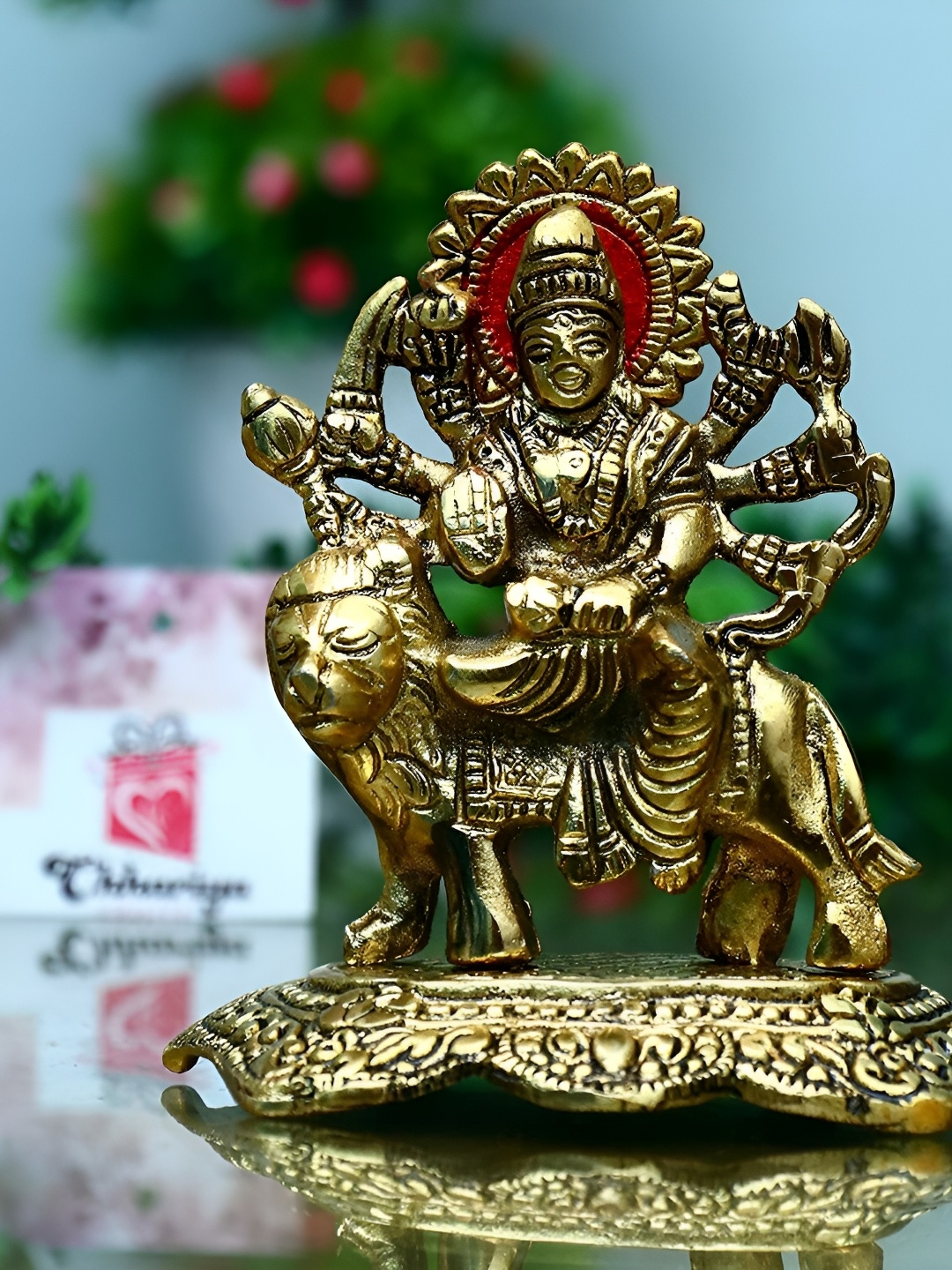 

Navyaksh Gold Toned & Beige Textured Religious Alloy Maa Durga Ji Murti Showpiece