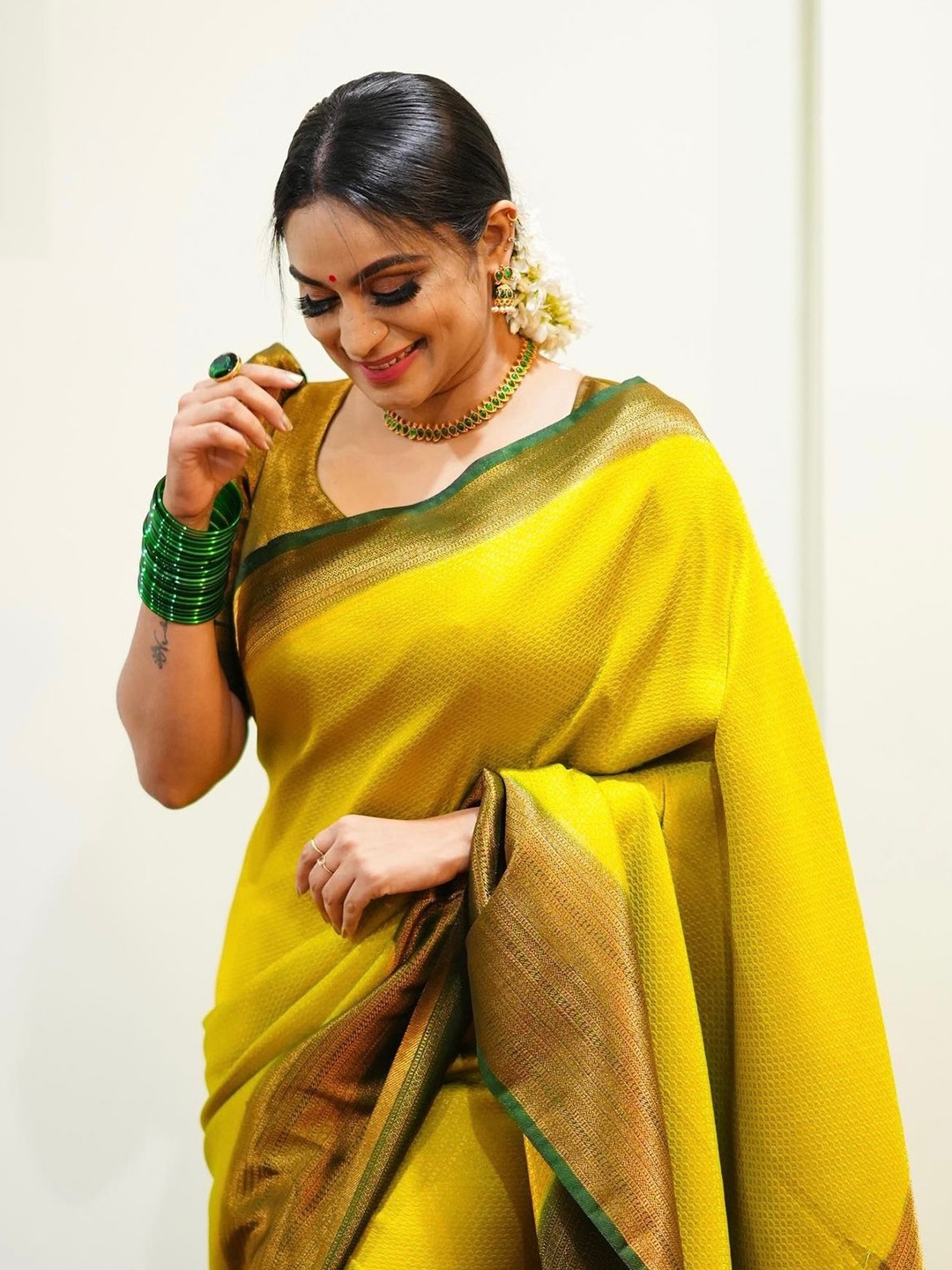 

Mitera Yellow & Green Ethnic Motifs Woven Design Zari Art Silk Saree