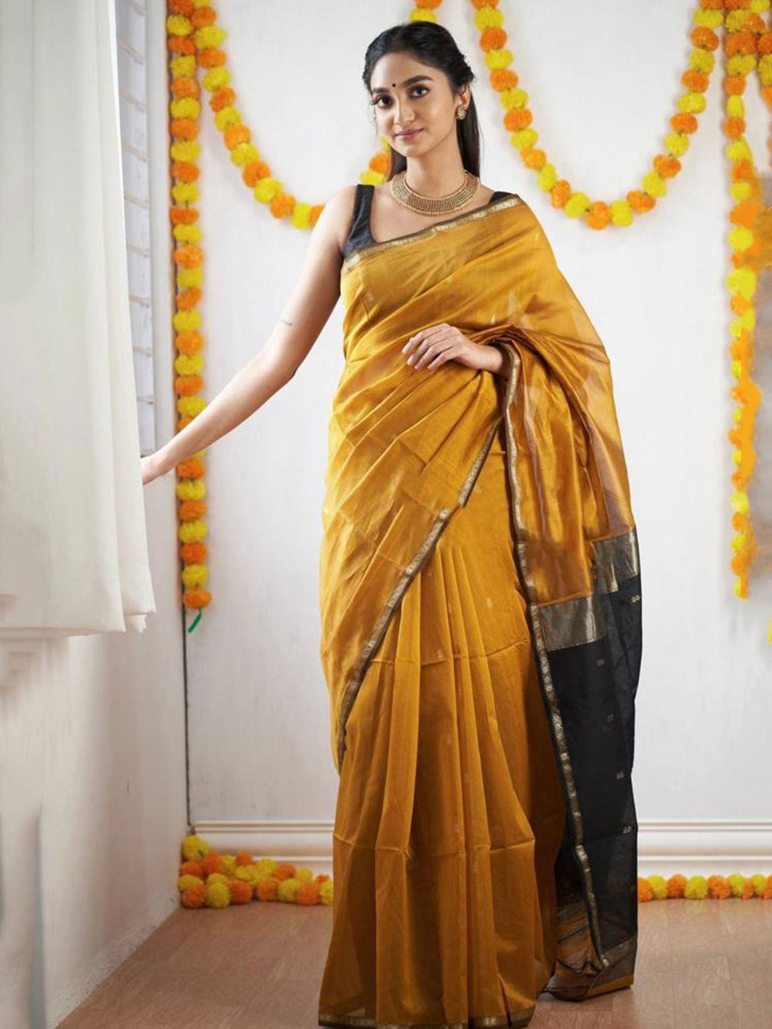 

Mitera Yellow & Black Ethnic Motifs Zari Art Silk Saree