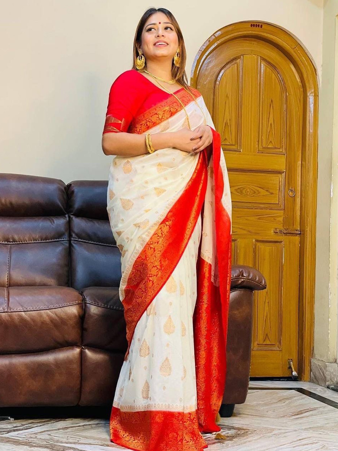 

Mitera White & Red Ethnic Motifs Woven Design Zari Art Silk Saree