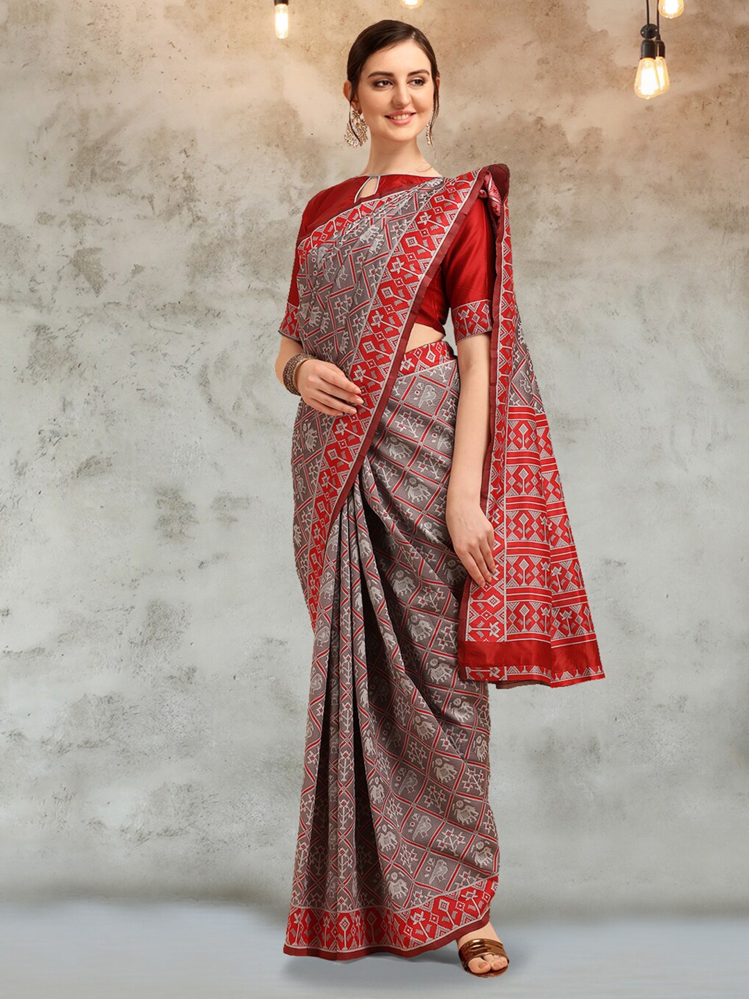 

Mitera Grey & Red Ethnic Motifs Woven Design Zari Silk Cotton Patola Saree