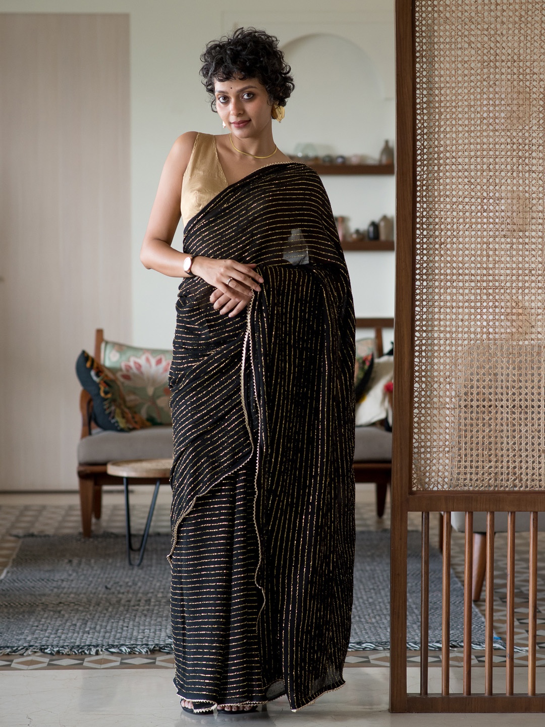 

Suta Black & Gold-Toned Striped Embellished Saree