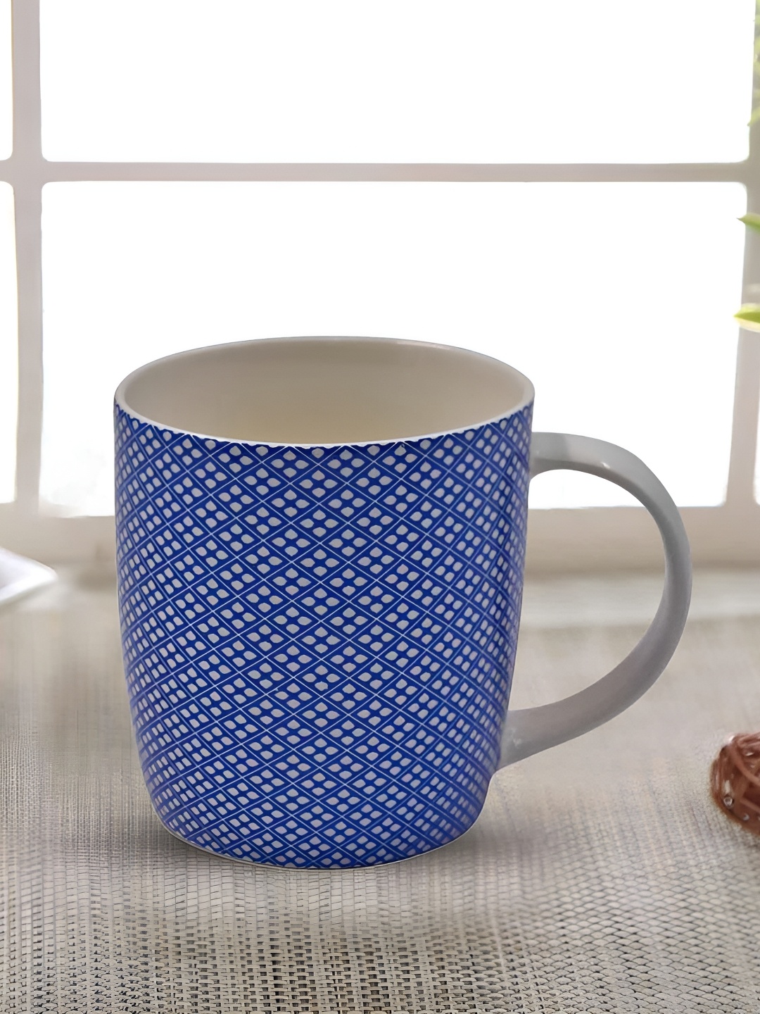 

Kookee Blue & White Printed Ceramic Mug 325 ML