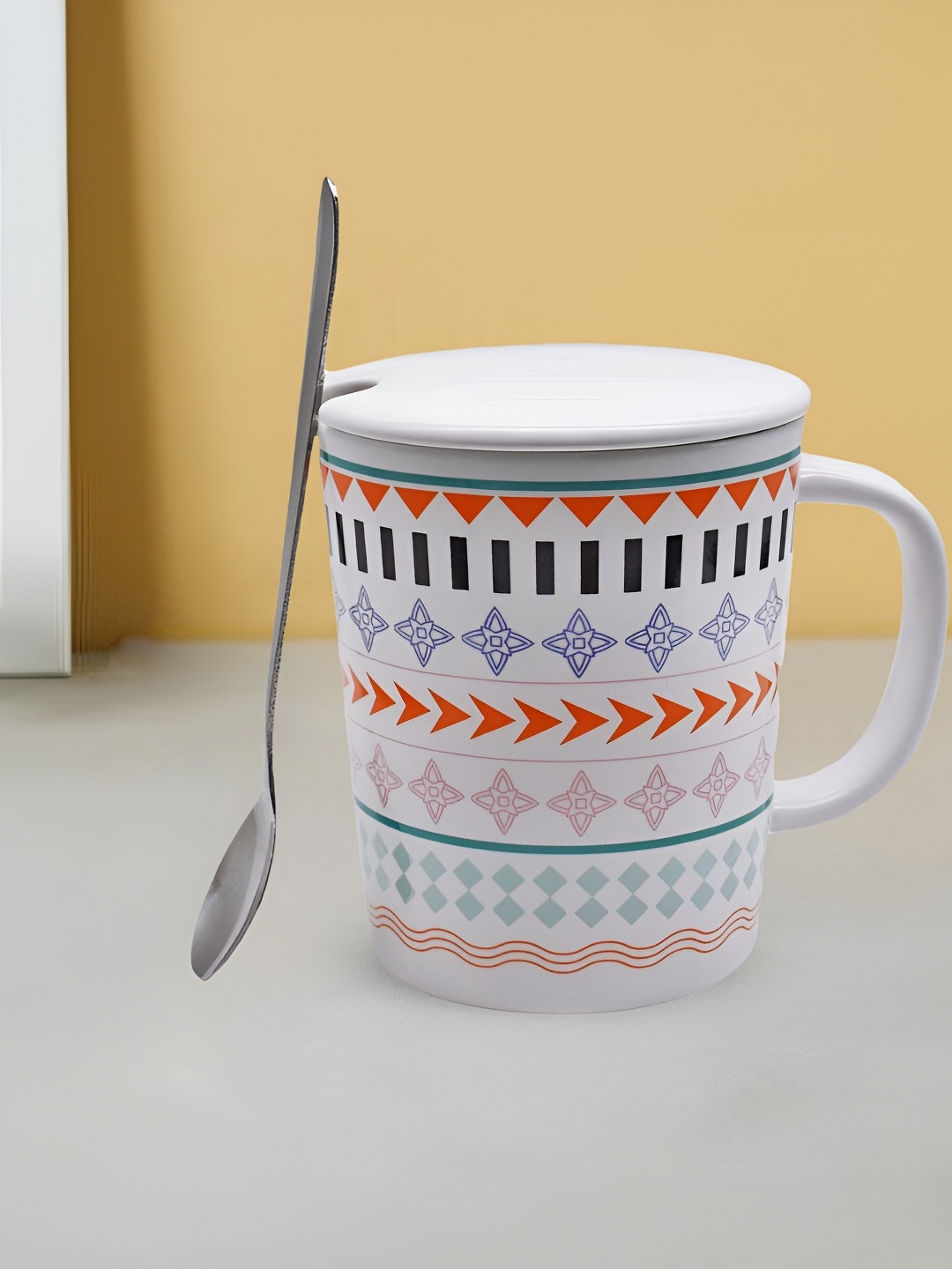 

Kookee White and Orange Printed Ceramic Mugs with Lid and Handle with Spoon 300 ml