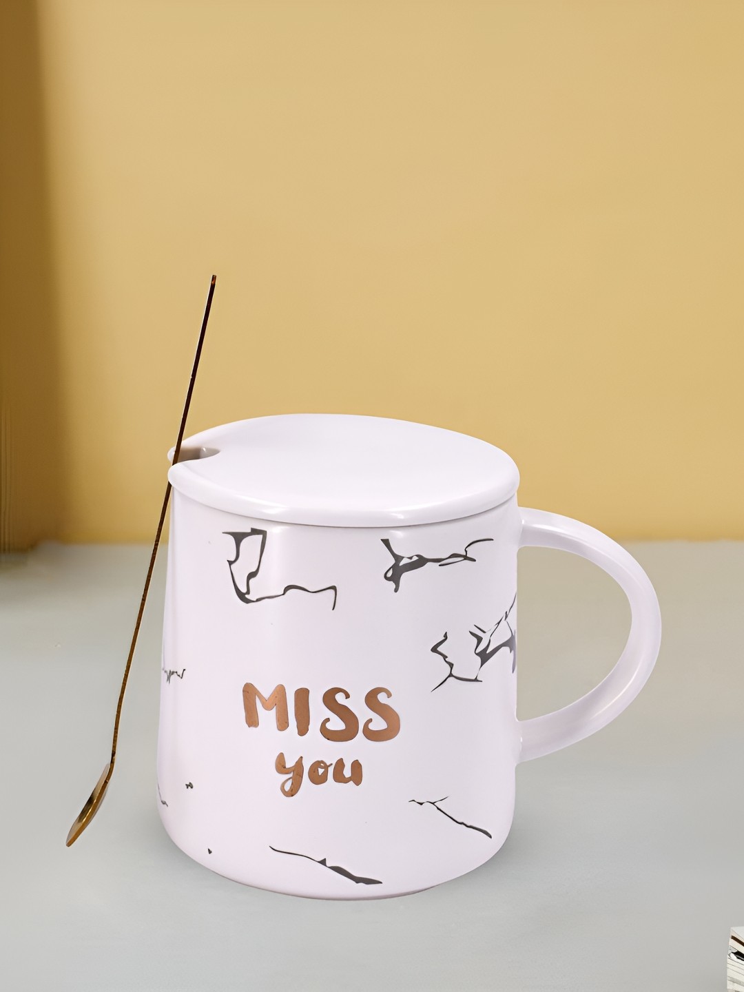 

Kookee White and GoldToned Printed Ceramic Mugs with Lid and Handle with Spoon 300 ml