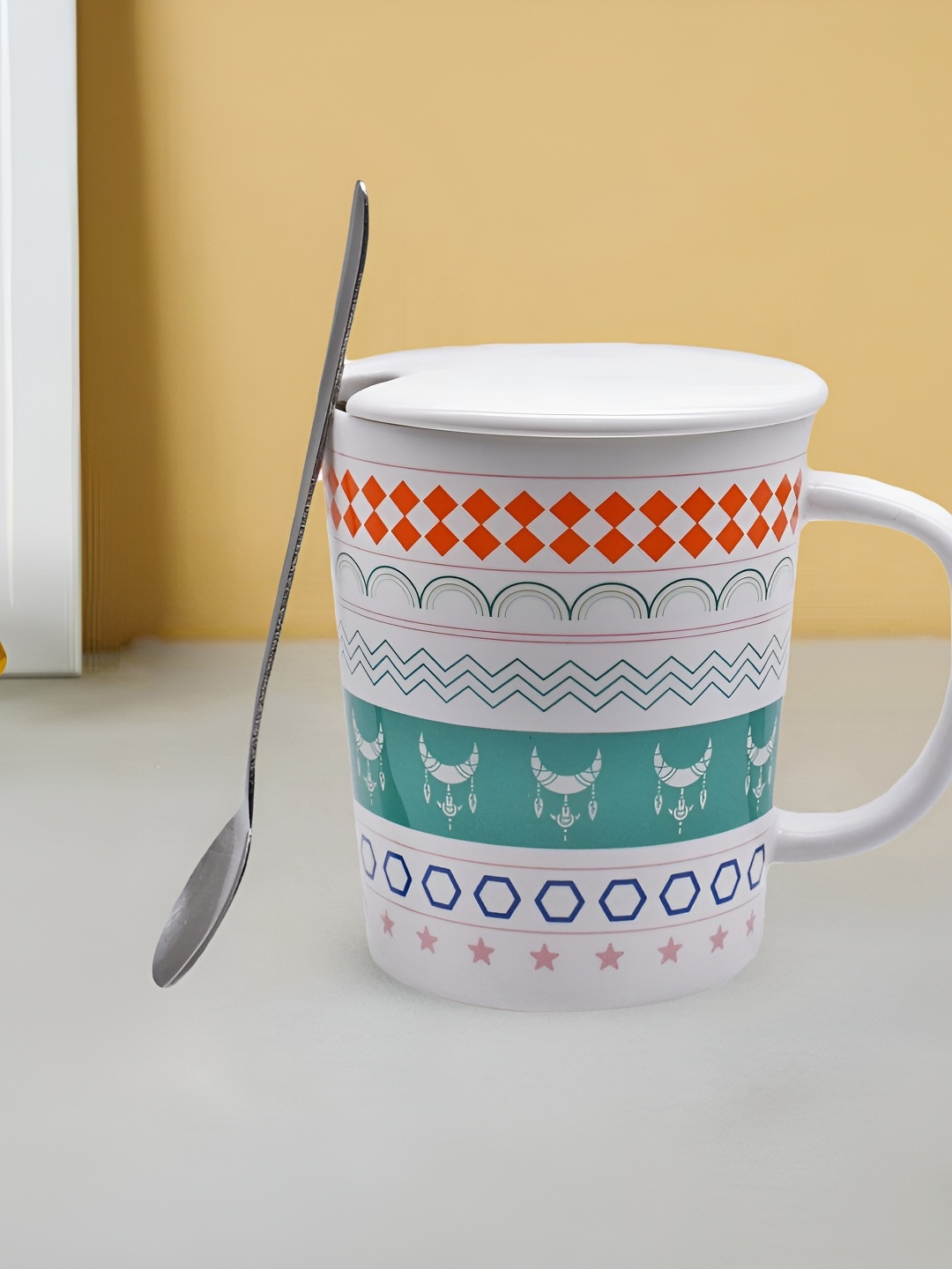 

Kookee White & Orange Printed Ceramic Mug With Lid & Handle & Spoon 300 ML