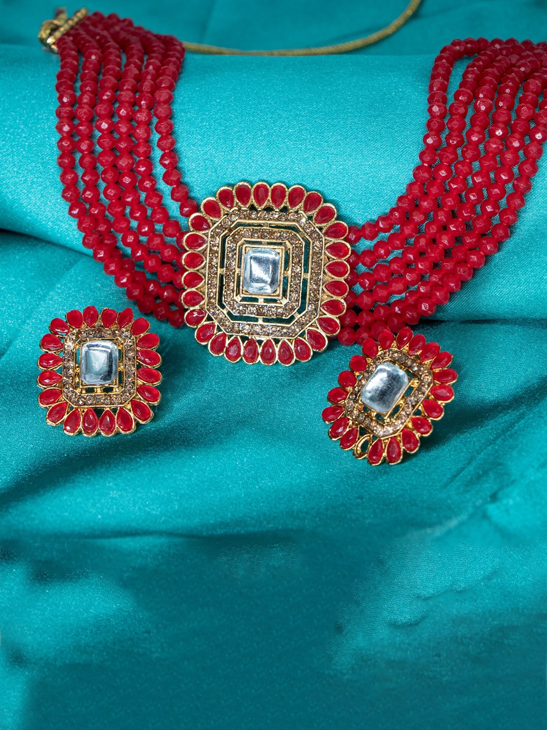 

Manikya Gold-Plated Artificial-Stones Studded & Pearl Beaded Jewellery Set