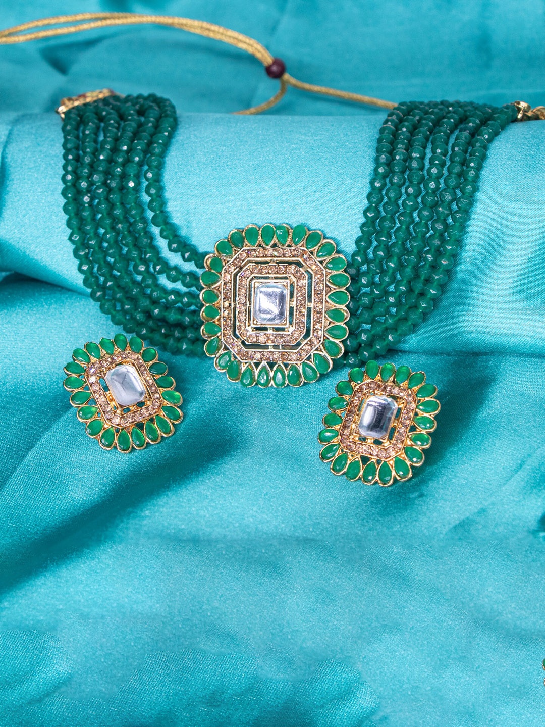 

Manikya Gold-Plated Stones Studded & Pearl Beaded Jewellery Set