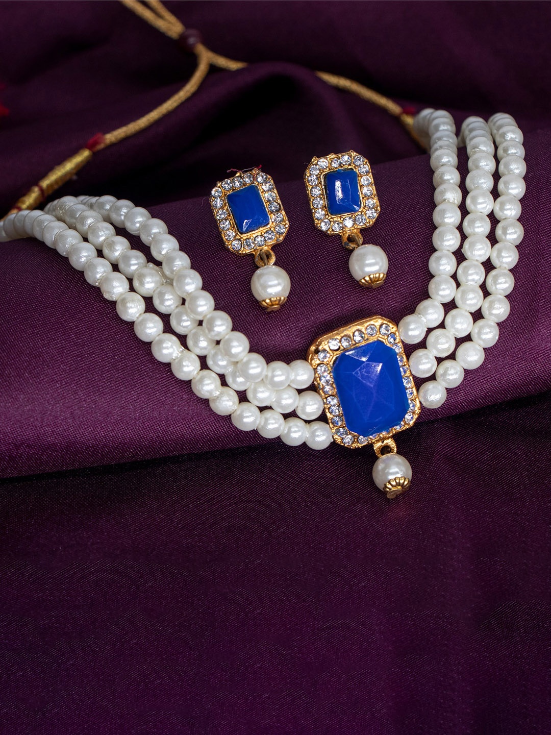 

Manikya Gold-Plated Stones Studded & Pearl Beaded Jewellery Set