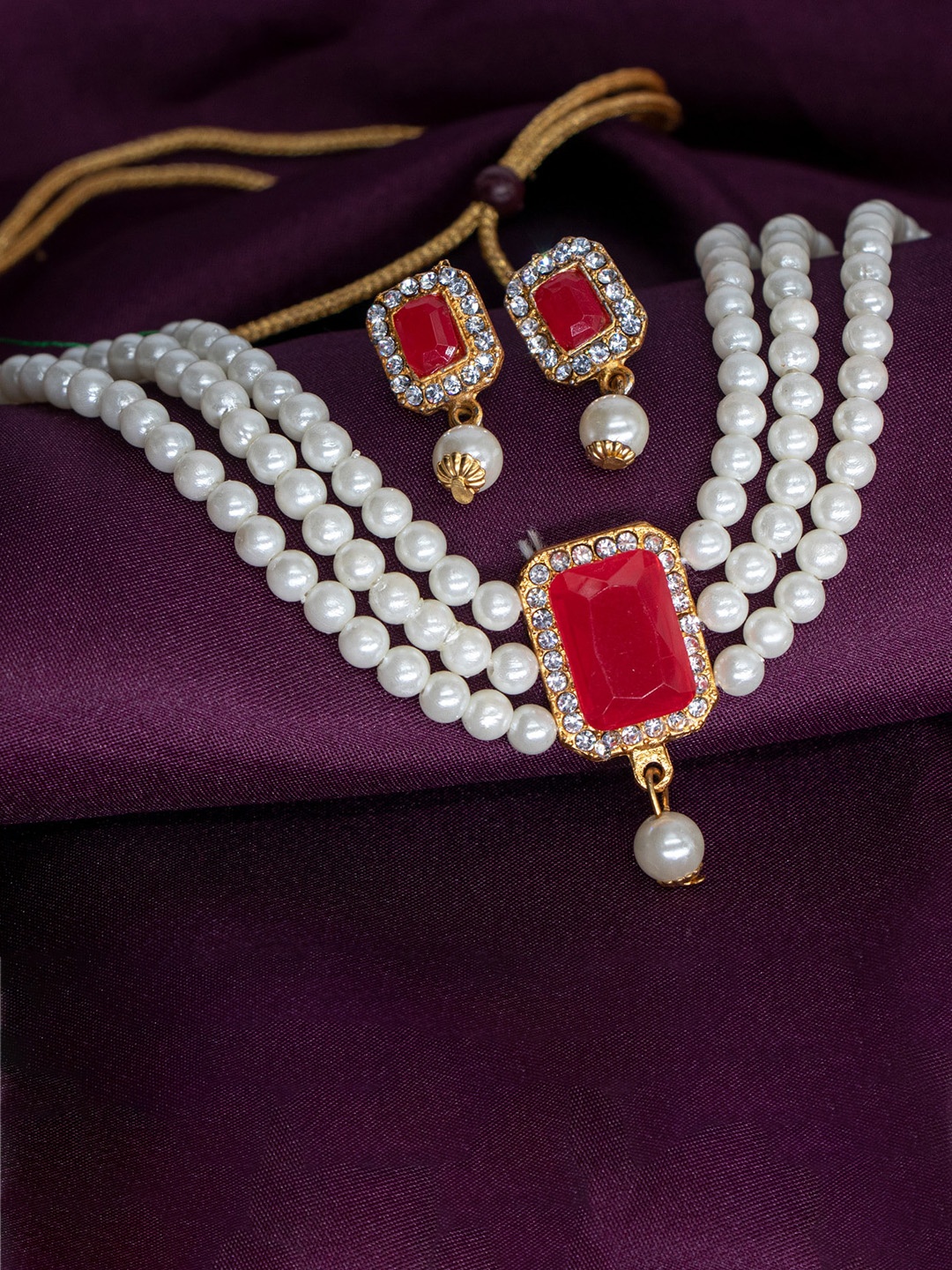 

Manikya Gold-Plated Stones Studded & Pearl Beaded Jewellery Set