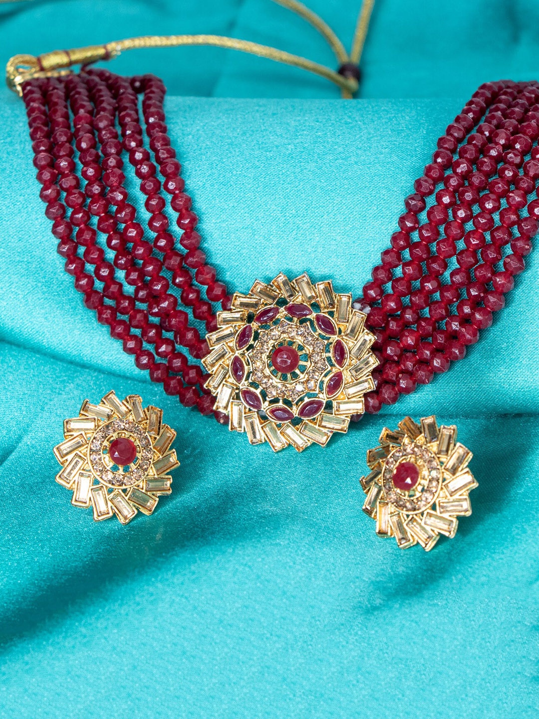 

Manikya Gold-Plated Stones Studded & Pearl Beaded Jewellery Set