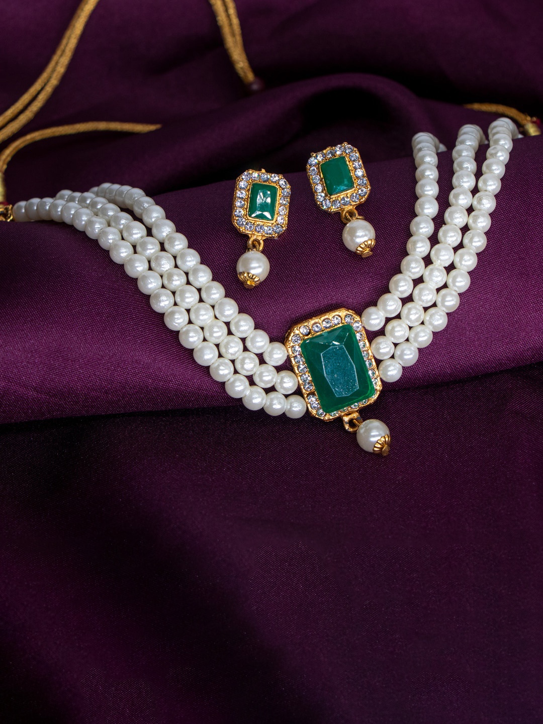

Manikya Gold-Plated Stones Studded & Pearl Beaded Jewellery Set