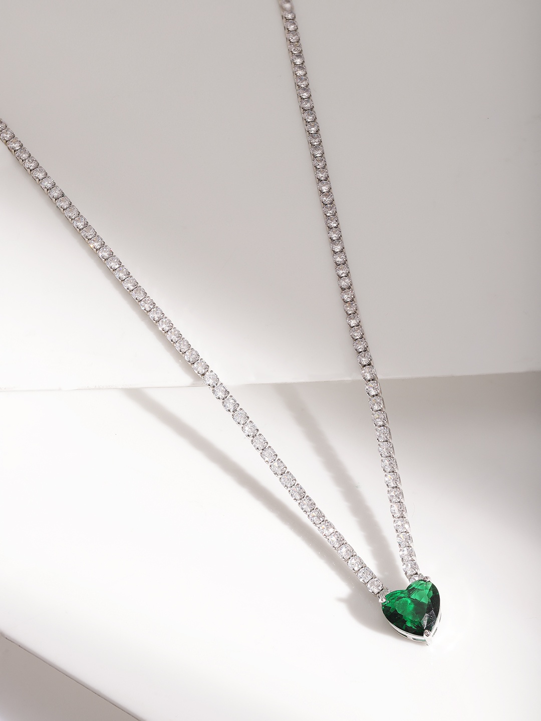 

Rubans Voguish Rhodium Plated Silver Tone Emerald & CZ Studded Heart Shaped Premium Necklace