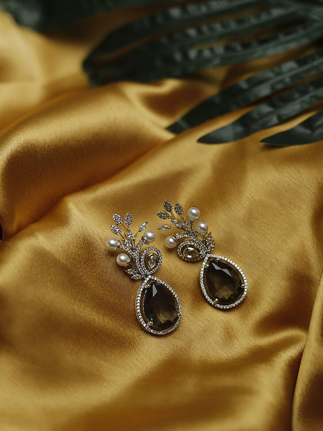 

Maansh Sterling Silver-Plated American Diamond Studded Contemporary Drop Earrings