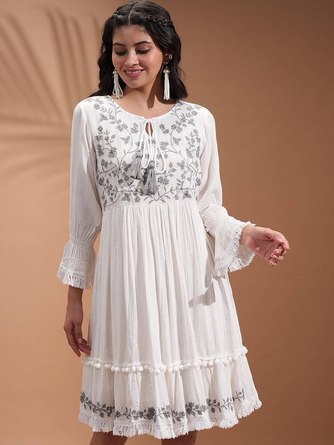 

Vishudh White Floral Embroidered Bell Sleeve Tasseled Pom-Pom Fit and Flare Ethnic Dresses