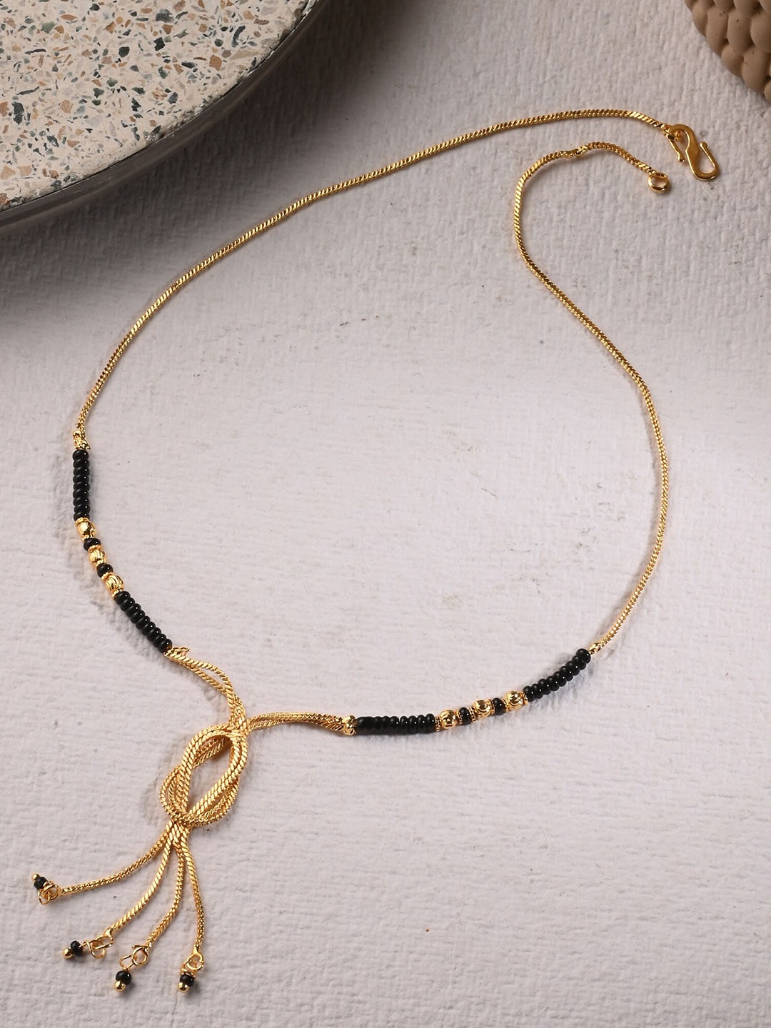 

AanyaCentric Gold-Plated AD-Studded Mangalsutra, Earring & Ring Set