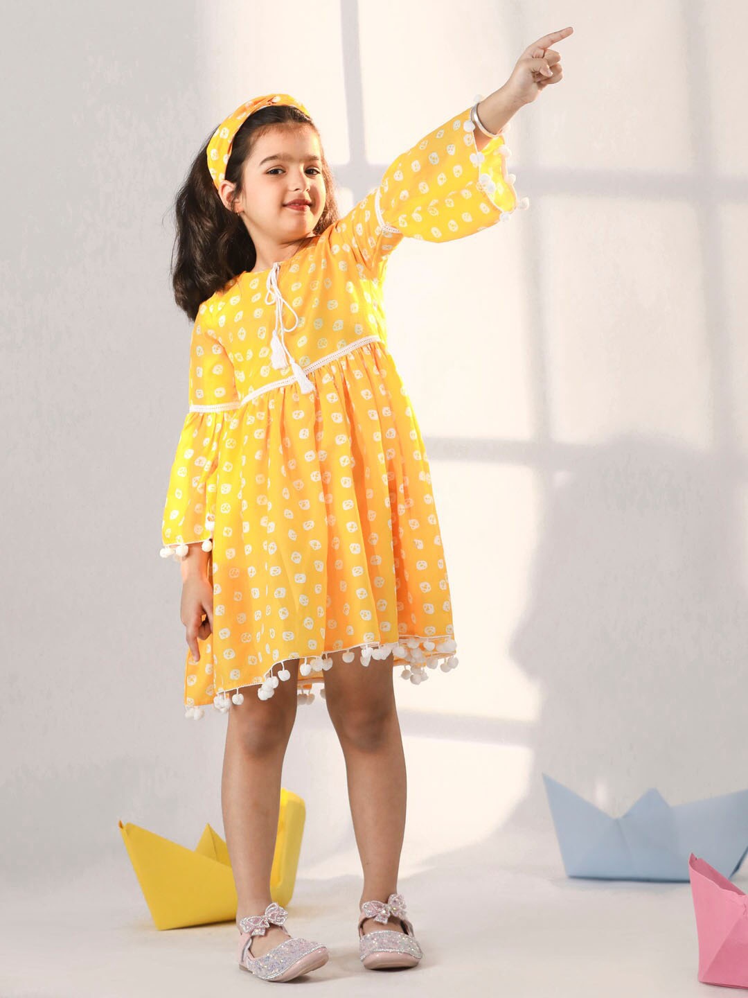 

VASTRAMAY Girls Printed Tie-Up Neck Bell Sleeves Pom-Pom Detail Cotton Fit & Flare Dress, Yellow