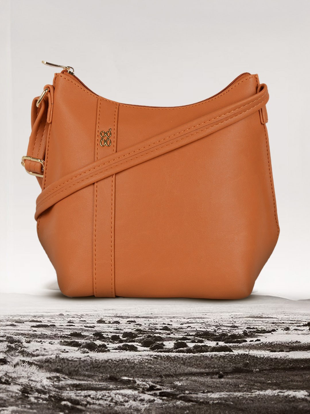 

Baggit Textured PU Oversized Structured Sling Bag with Tasselled, Orange