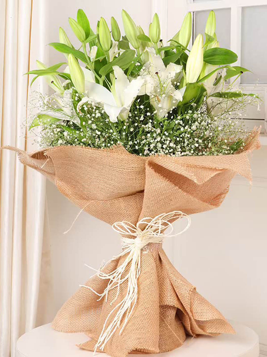 

Floweraura White 7-Pcs Fresh Live Lilies Flowers Bouquet With Jute Wrapping, Green