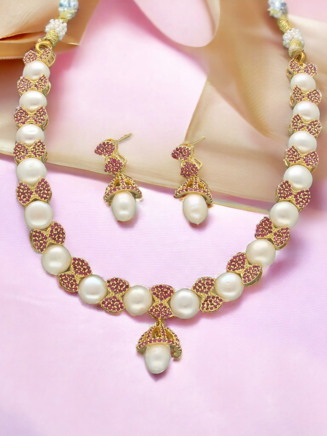 

Sri Jagdamba Pearls Dealer Gold-Plated Stone Studded & Pearls Beaded Jewellery Set