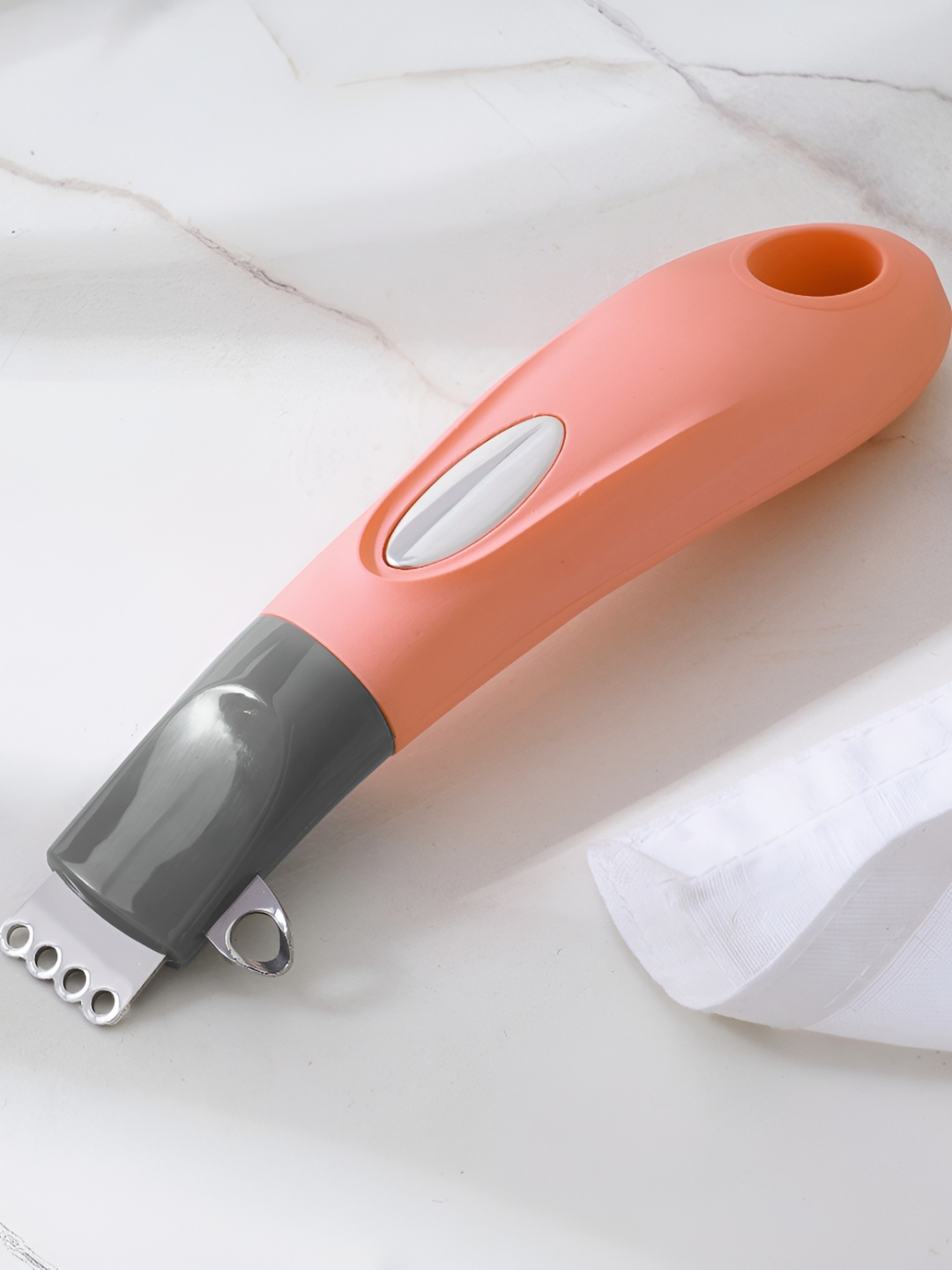 

Home Centre Peach-Coloured Stainless Steel Peeler
