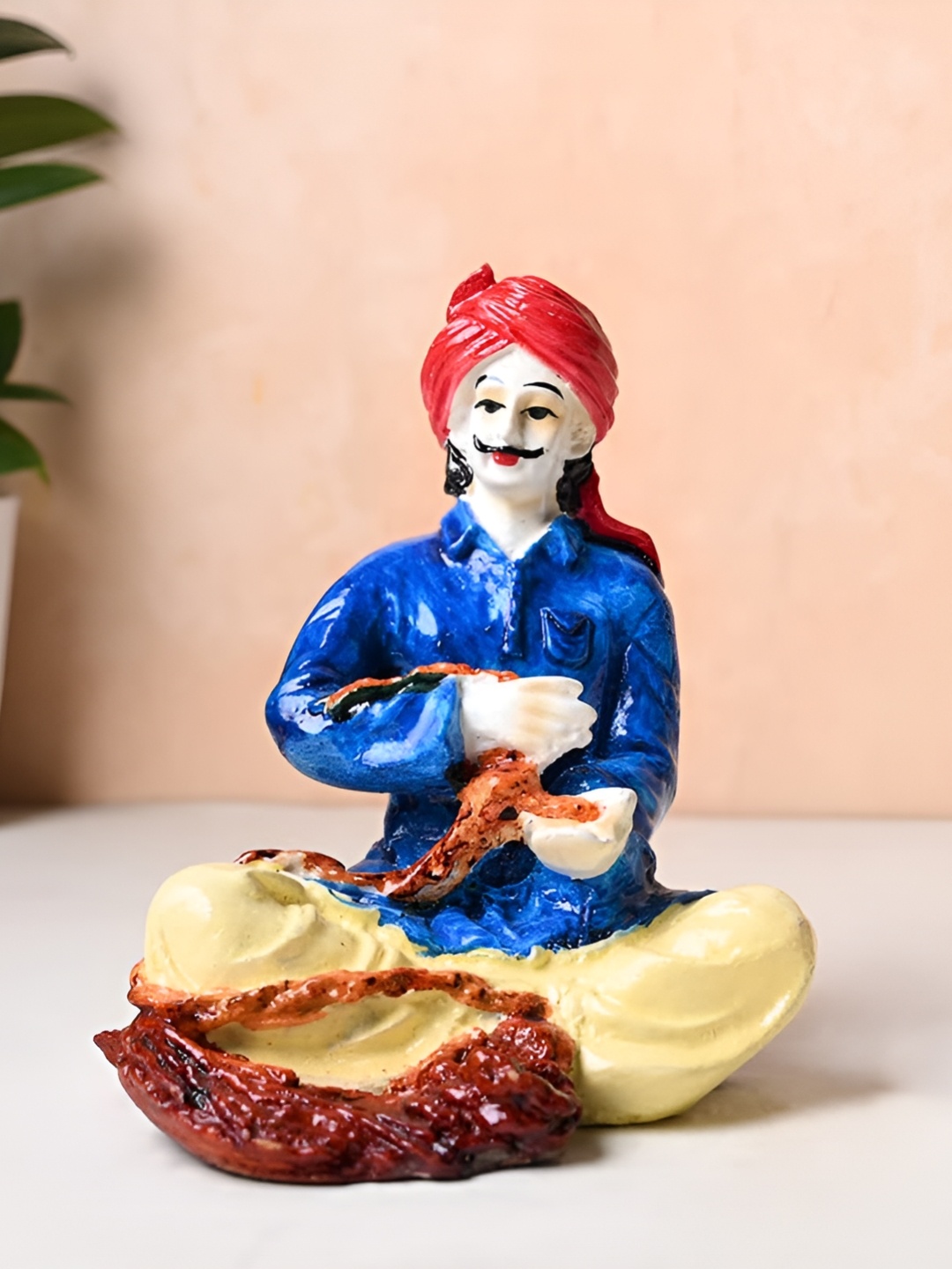 

Floweraura Blue & Red Rasthani Man Figurine Showpiece