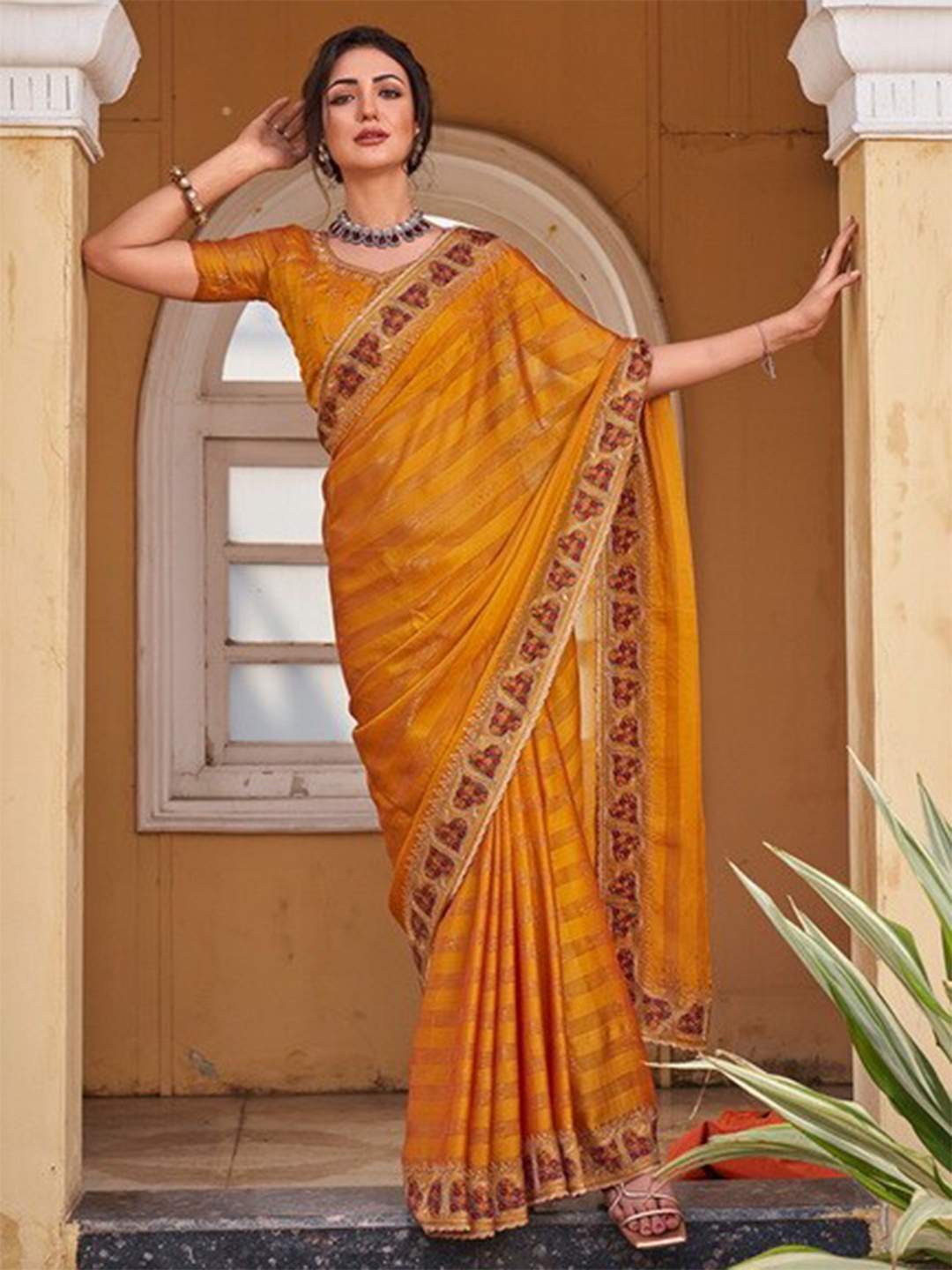 

Kalista Striped Embellished Bordered Pure Chiffon Saree, Mustard