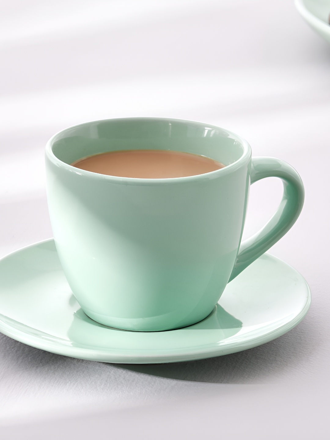 

Home Centre Green Solid Porcelain Matte Cups and Saucers Set of Cups and Mugs