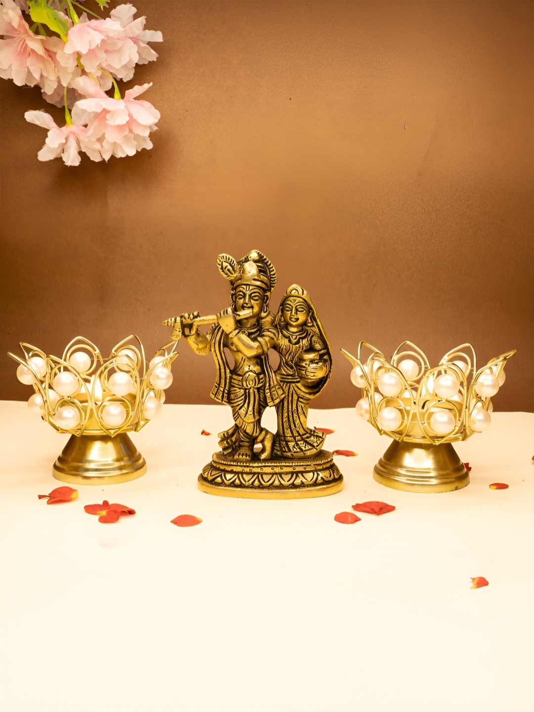 

Ekhasa Gold Toned 3 Pieces Textured Radha Krishna Idol & Tealight Candle Holders