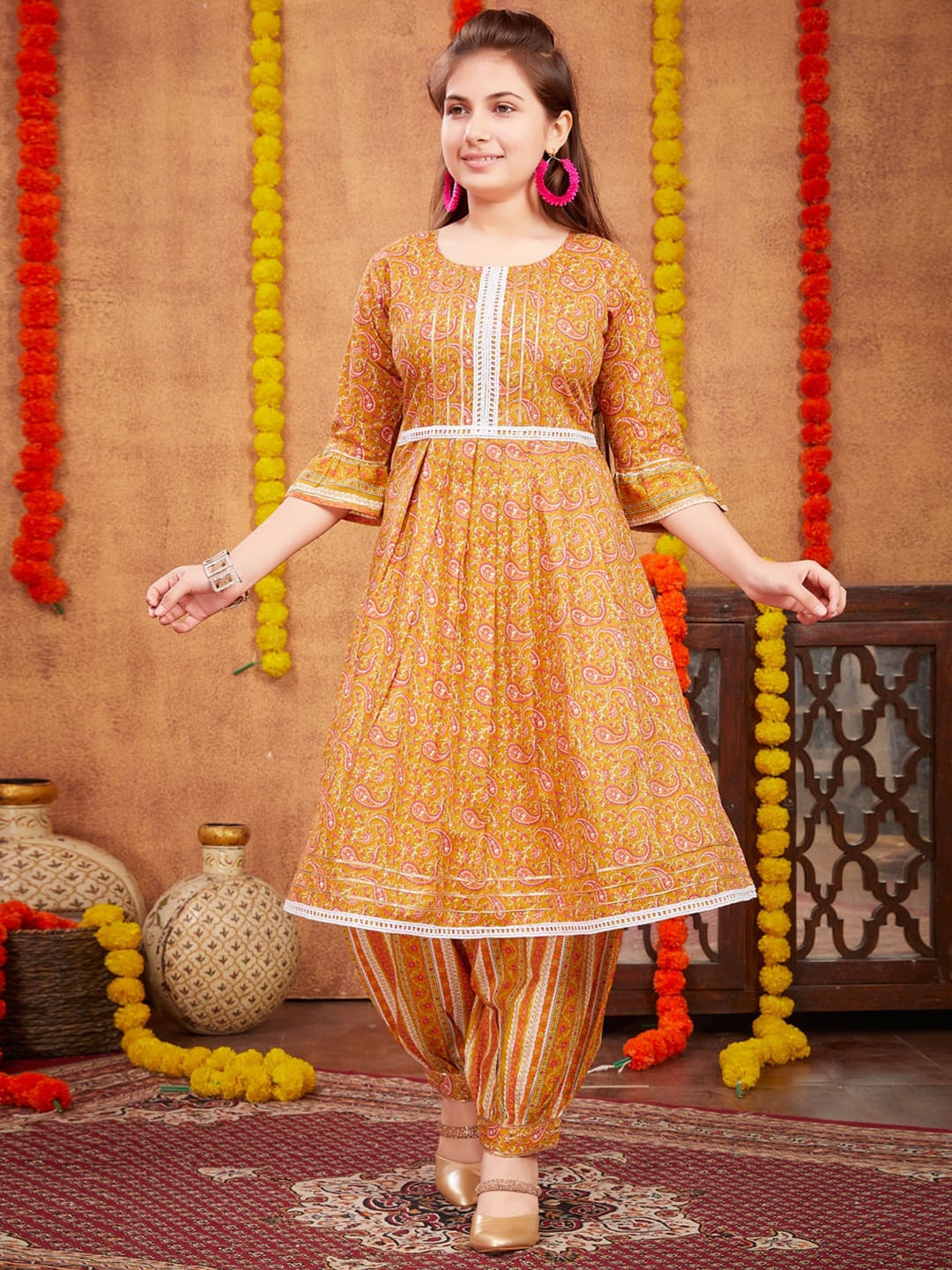 

Aarika Girls Paisley Printed Bell Sleeves Pleated Pure Cotton A-Line Kurta with Patiala, Yellow