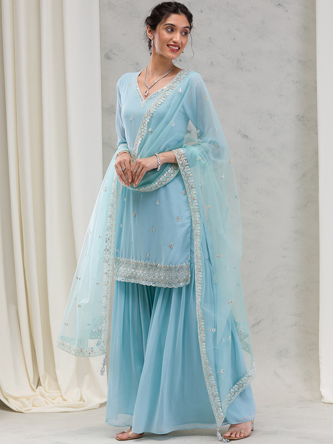 

Koskii Women Ethnic Motifs Embroidered Regular Beads and Stones Kurta with Sharara & With Dupatta, Blue