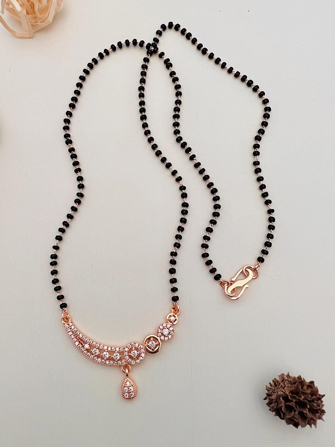 

Anouk Rose Gold Toned Rose Gold Plated American Diamond Studded & Beaded Mangalsutra
