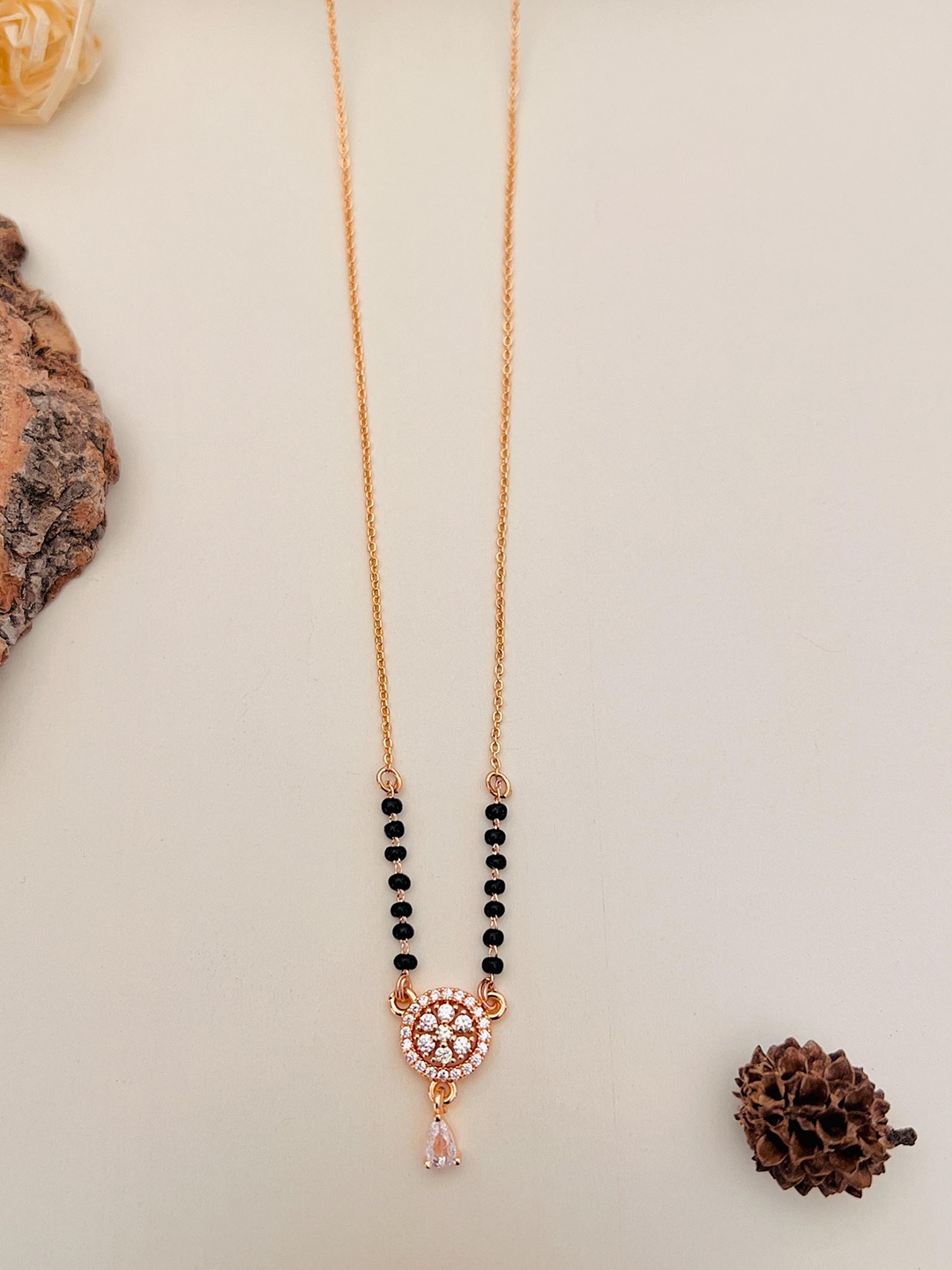 

Anouk Rose Gold Toned Rose Gold Plated American Diamond Studded & Beaded Mangalsutra