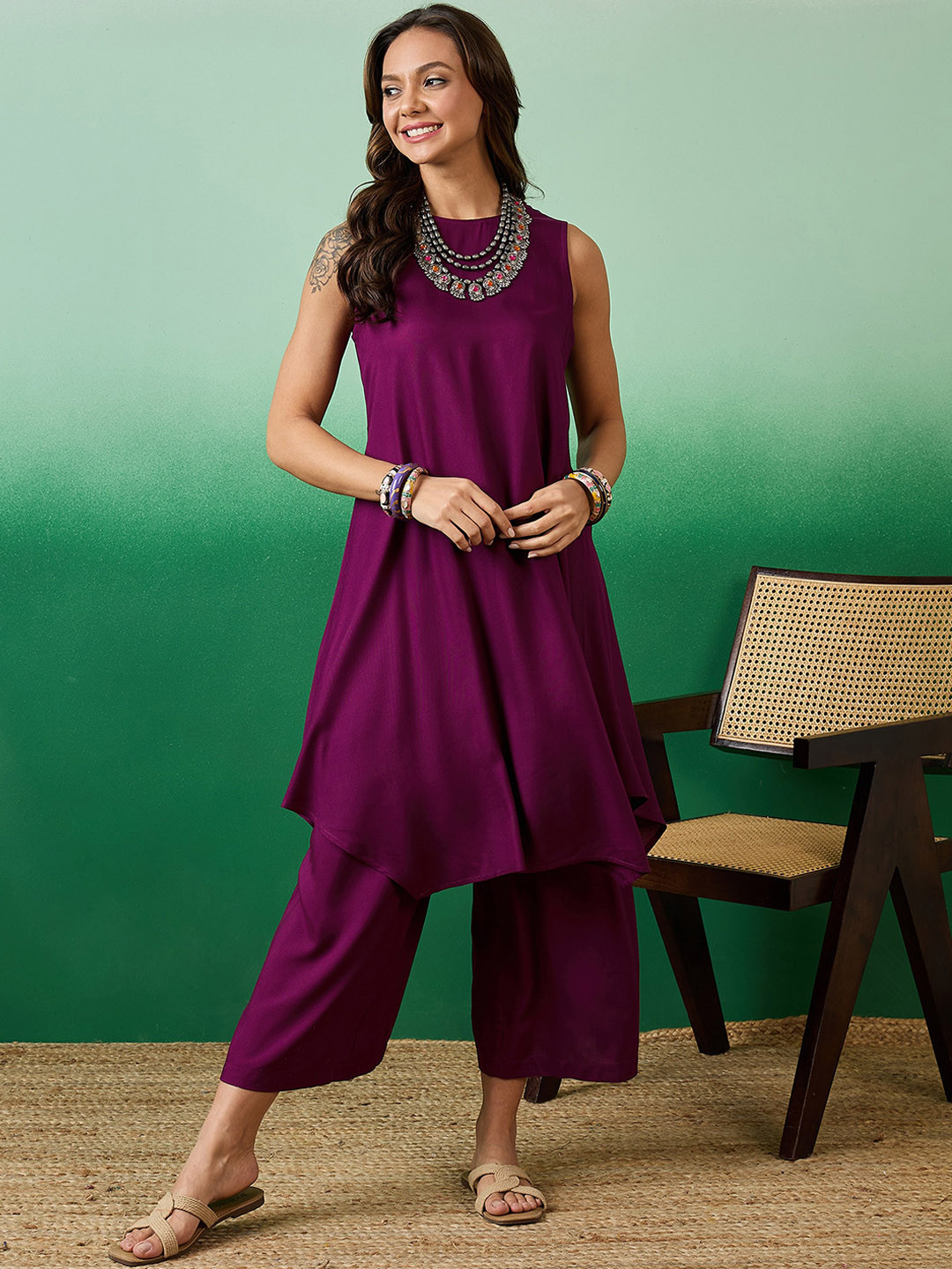 

Sangria Sleeveless Round Neck Asymmetric A Line Kurta With Palazzos, Maroon
