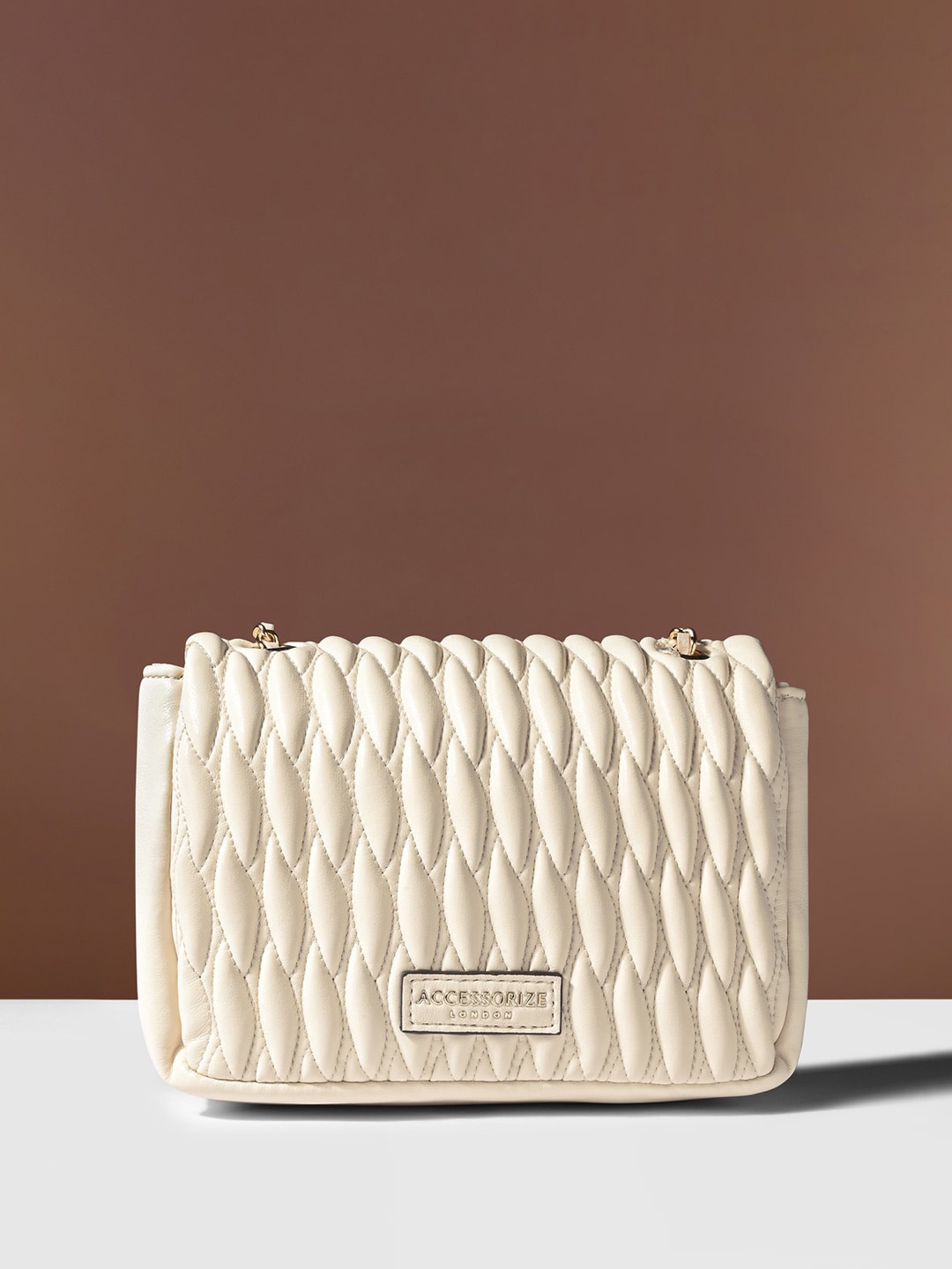 

Accessorize Textured Synthetic Leather Structured Quilted Sling Bag, Cream