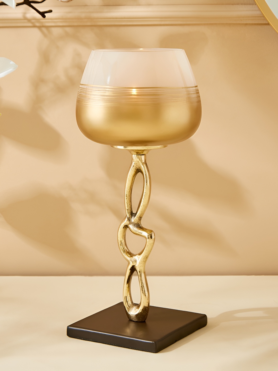 

Home Centre Gold Toned & White Glass Candle Holder