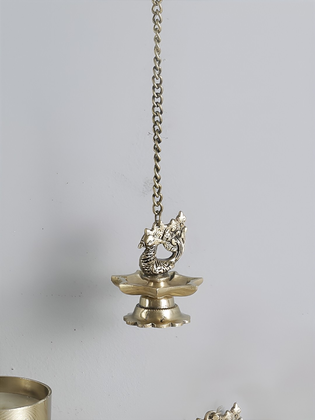 

Two Moustaches Brass Peacock Carved Hanging Diya Set, Gold