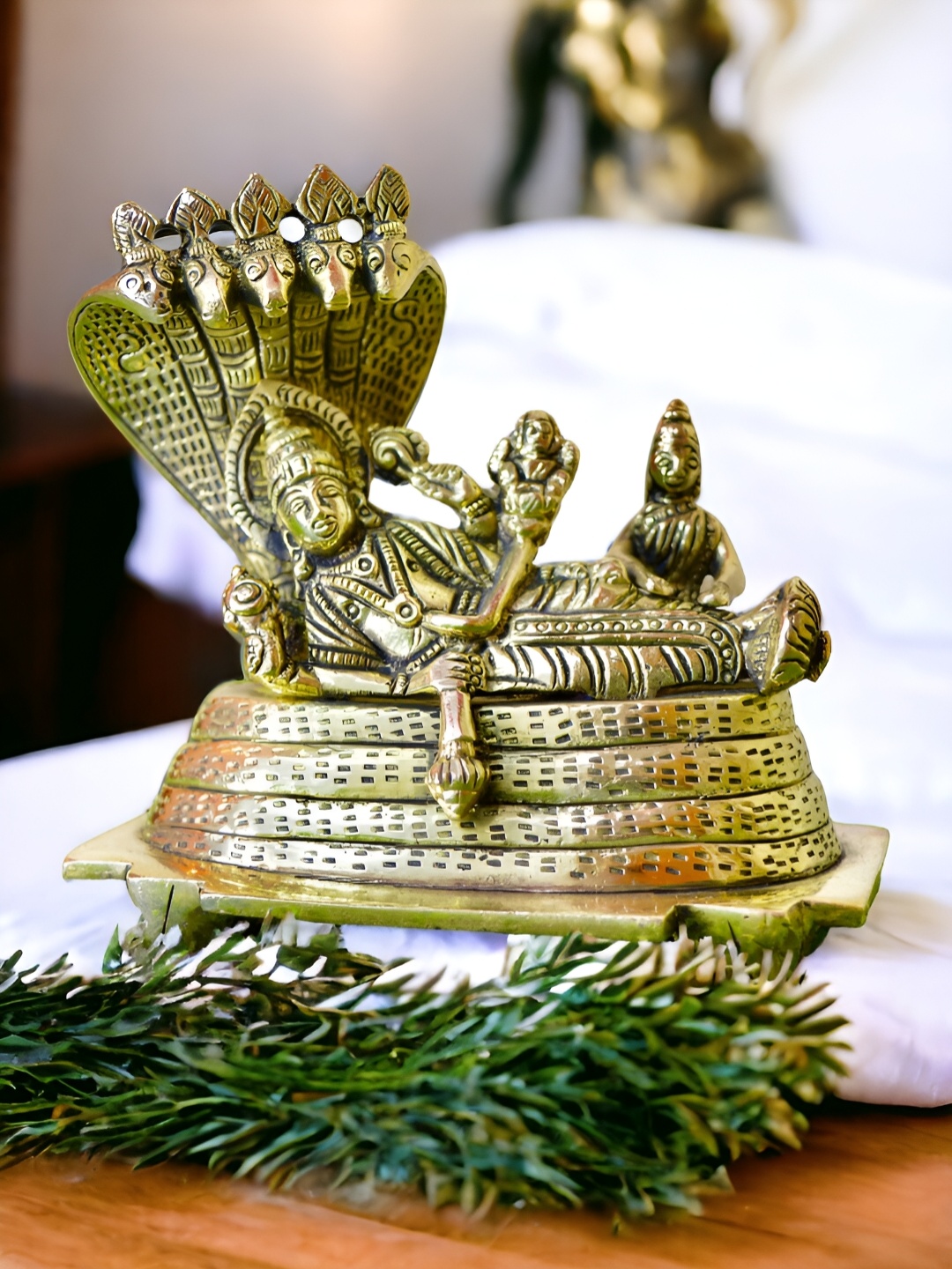 

Aakrati Gold-Toned Vishnu Laxmi Sitting On Sheshnag Medium Religious Idol Brass Showpiece