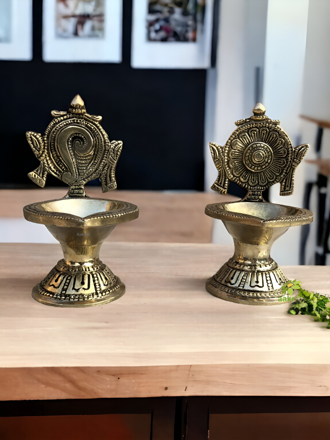 

Aakrati Gold Toned 2 Pieces Brass Shankh & Chakra Diyas