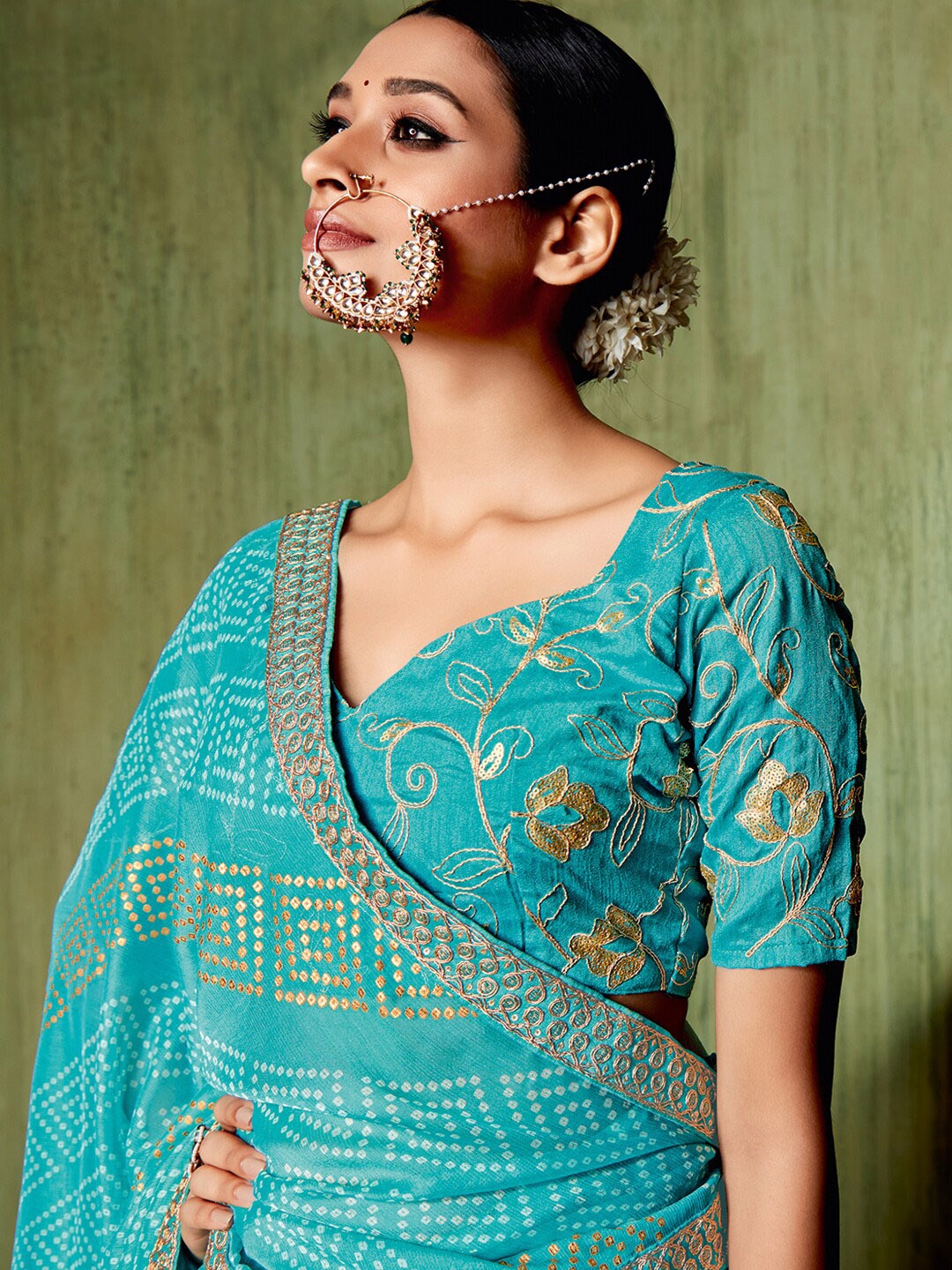 

Mitera Turquoise Blue Bandhani Printed Sequinned Pure Chiffon Saree