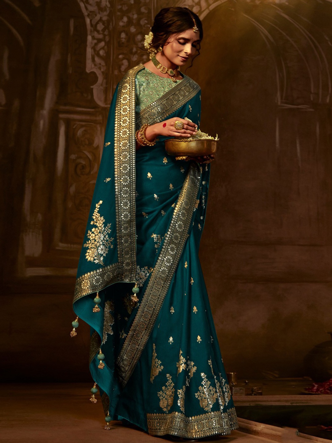 

Mitera Teal Blue Ethnic Motifs Embroidered Zari Banarasi Saree