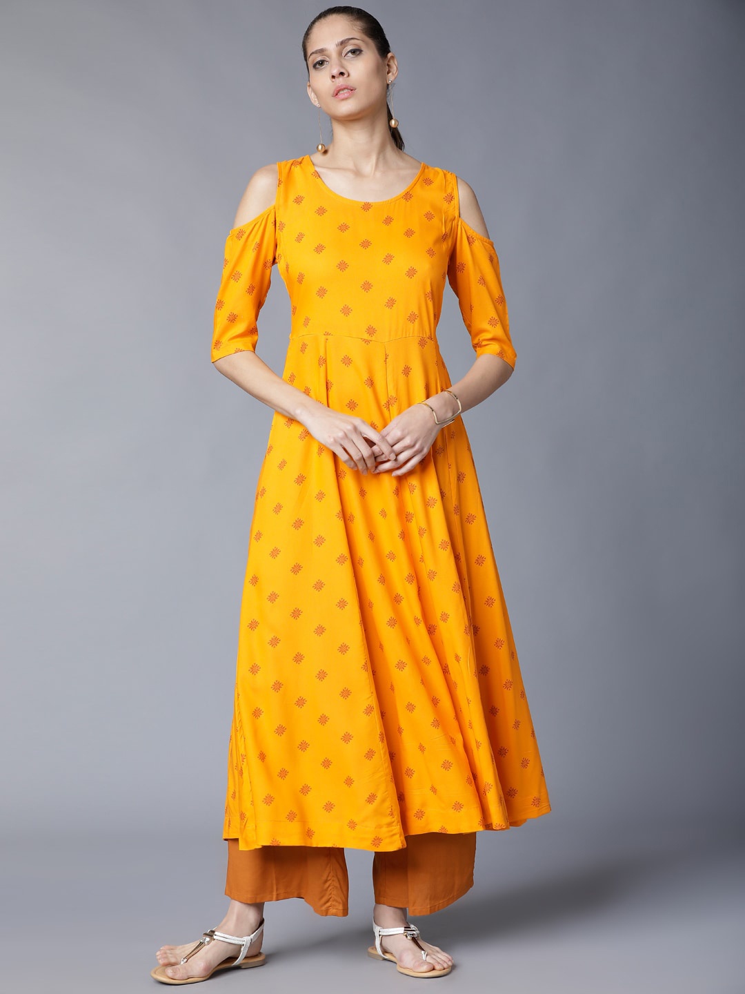 

Vishudh Yellow Ethnic Motifs Printed Cold-Shoulder Sleeves Pleated A-Line Kurta