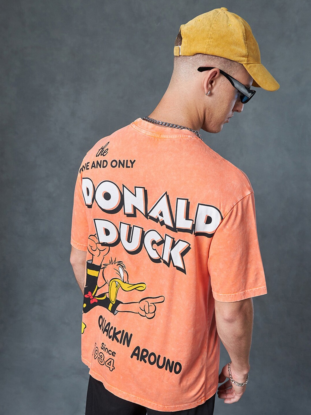 

Bewakoof Donald Duck Printed Round Neck Short Sleeves Acid Wash Cotton Oversized T-shirt, Orange