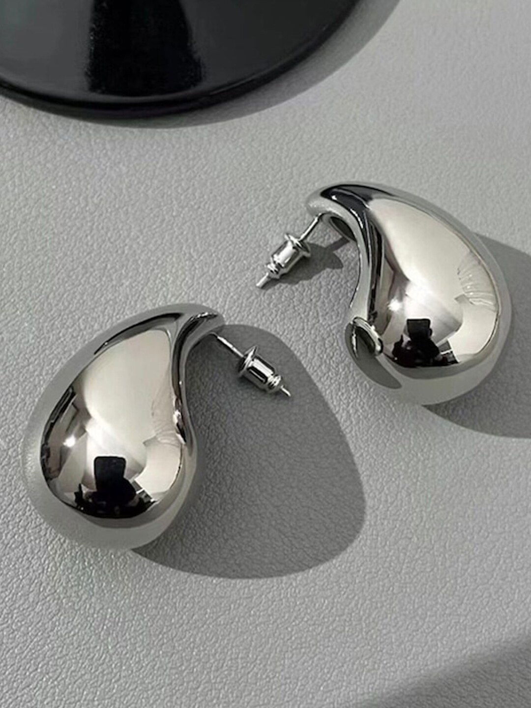 

Xivir Stainless Steel Silver- Plated Teardrop Shaped Stud Earrings