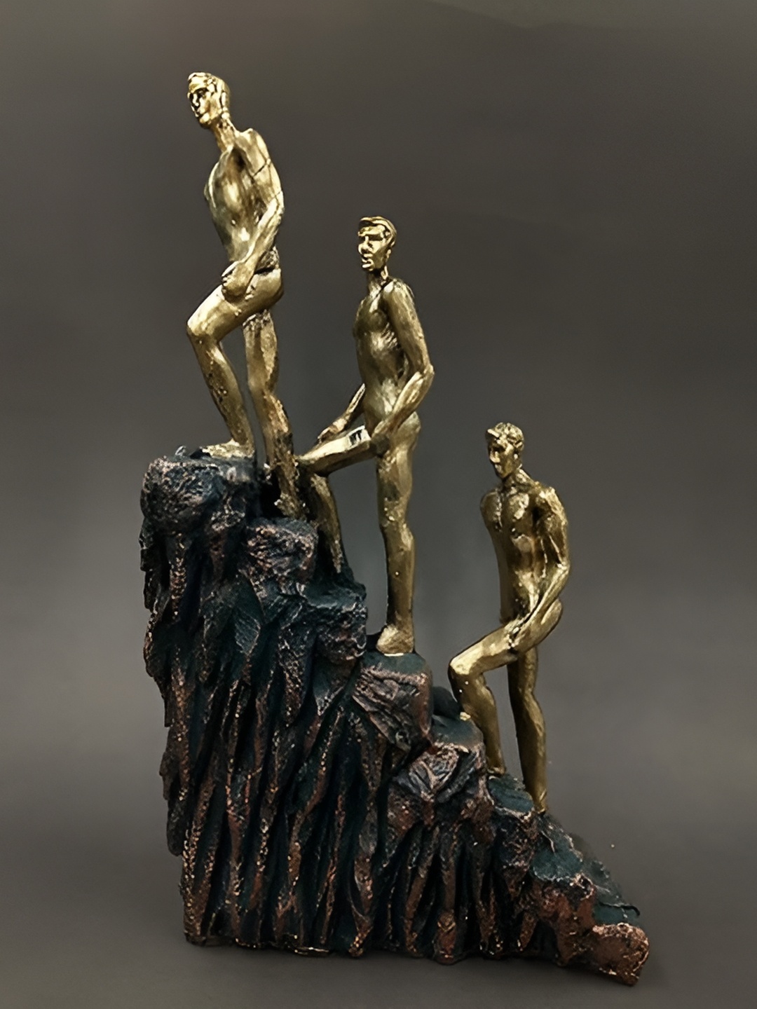 

Aura Gold-Toned & Black Figurine 3 Man On Stairs Showpiece
