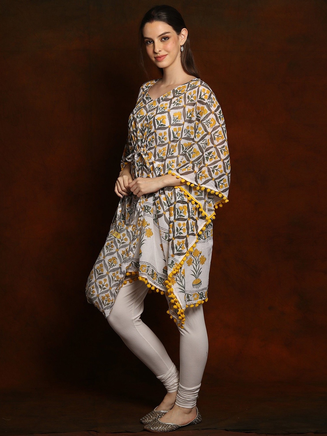 

Exotic India Yellow Sunflower Pure Cotton Short Kaftan with Pom Poms Border and Cotton Bag