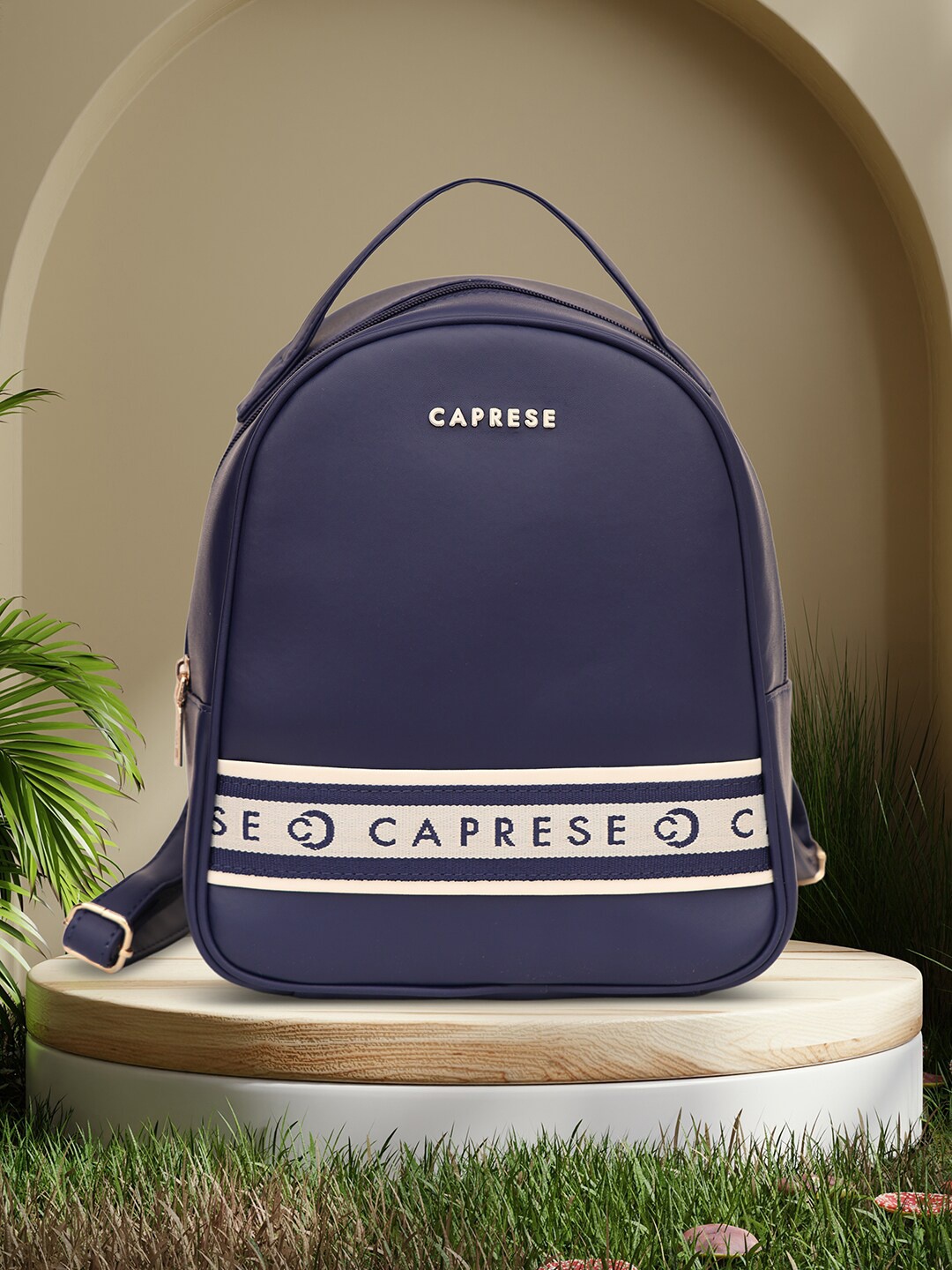 

Caprese Women Trinity Fashion Brand Logo Medium Backpack, Navy blue